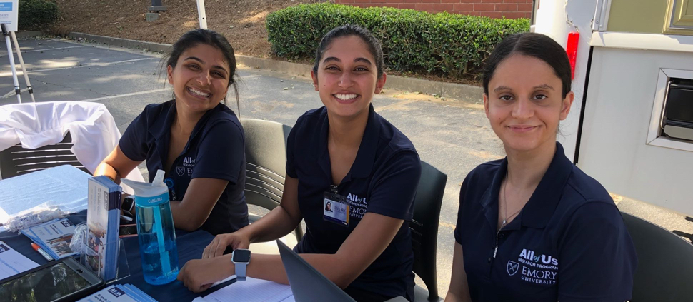 Image of three volunteers from Emory University smiling
