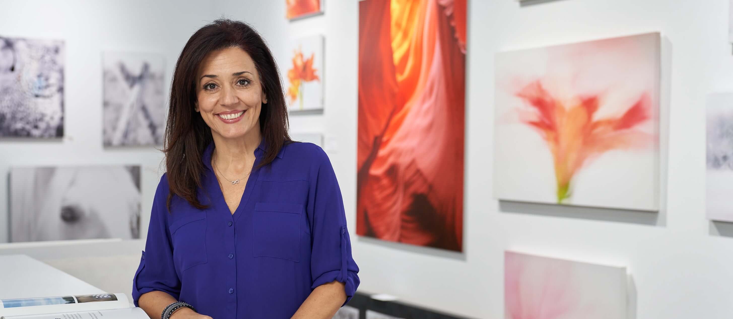 Image of a smiling woman in a gallery
