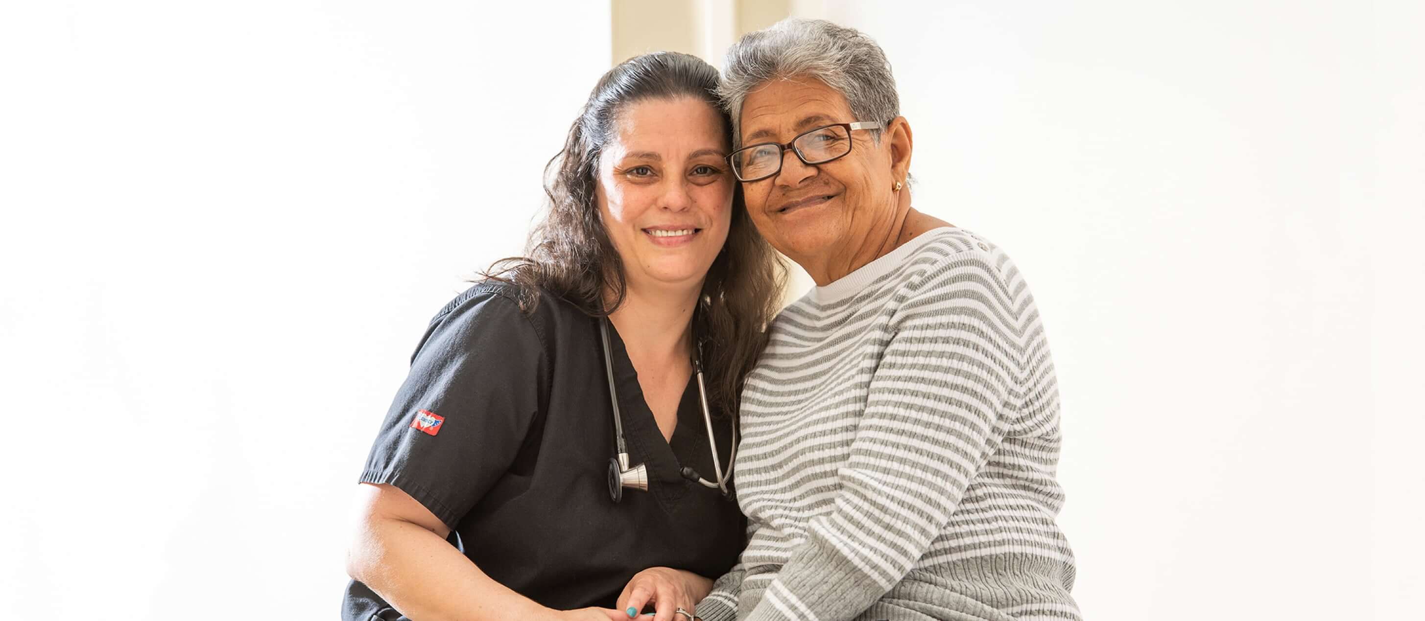 Image of nurse and older adult patient smiling
