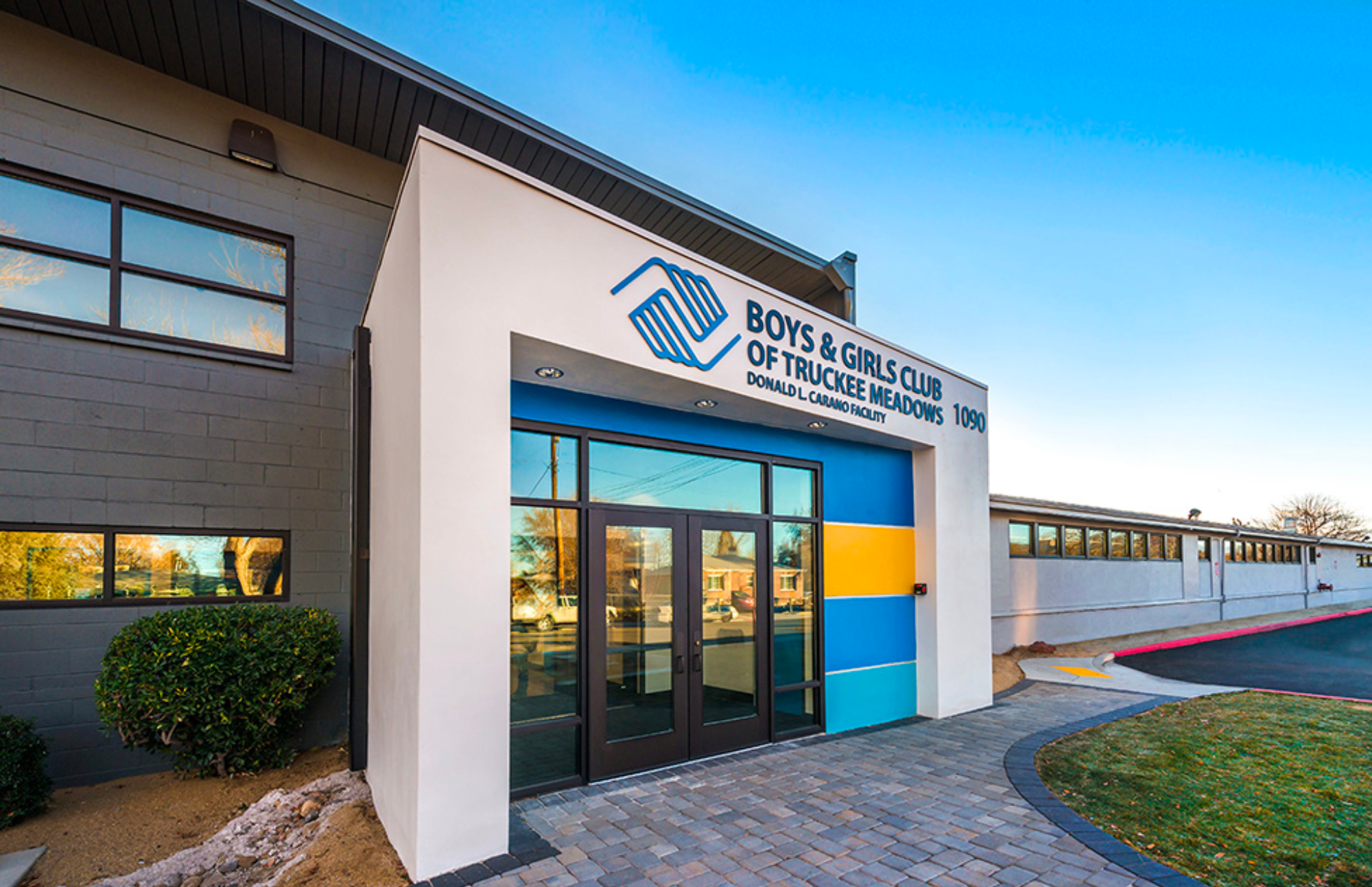 Front entrance of a modern building featuring Boys and Girls Club of Truckee Meadow signage over the door.