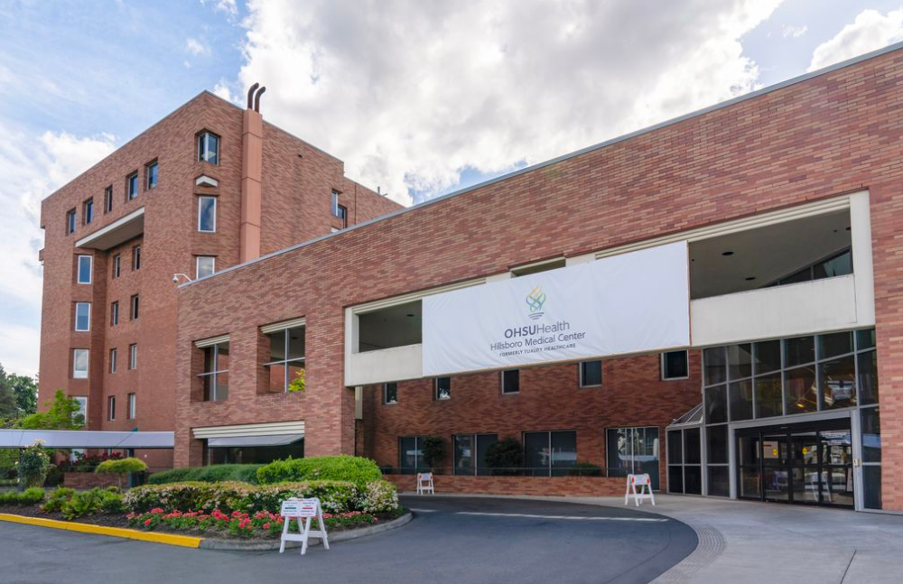 Brick hospital building with a textile sign reading OHSU Hillsboro Medical Center.