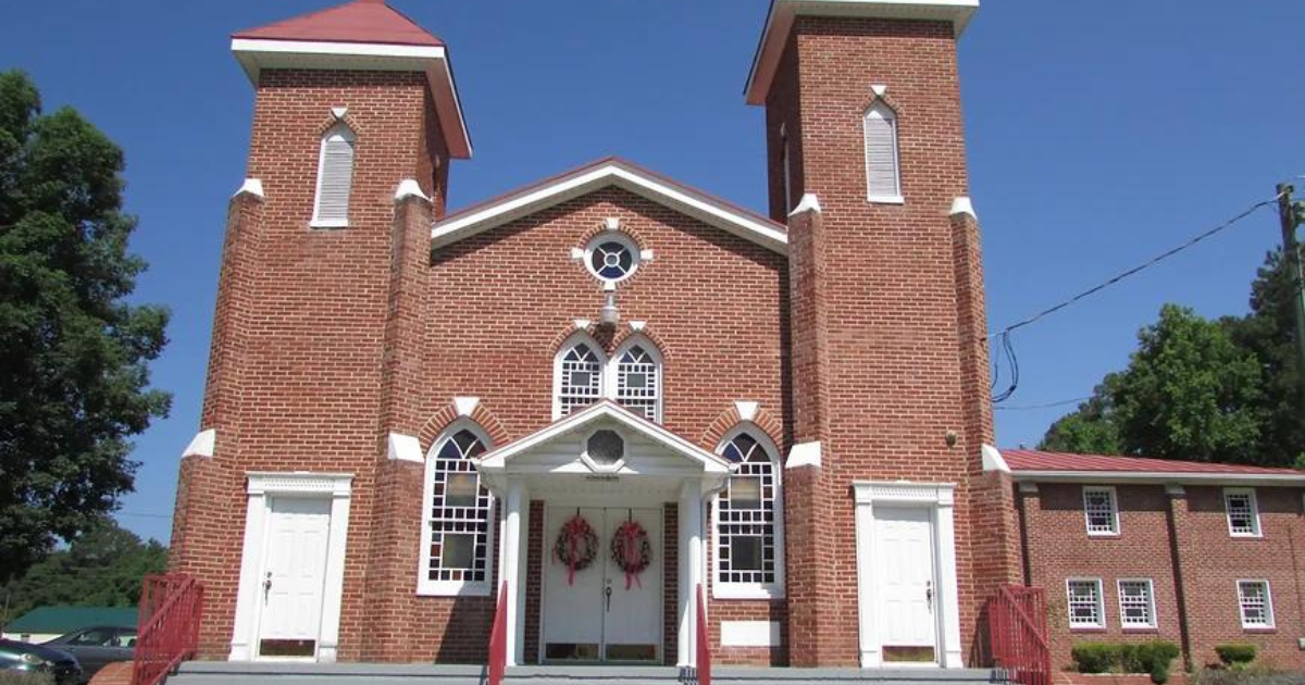 Red bricked church with white doors