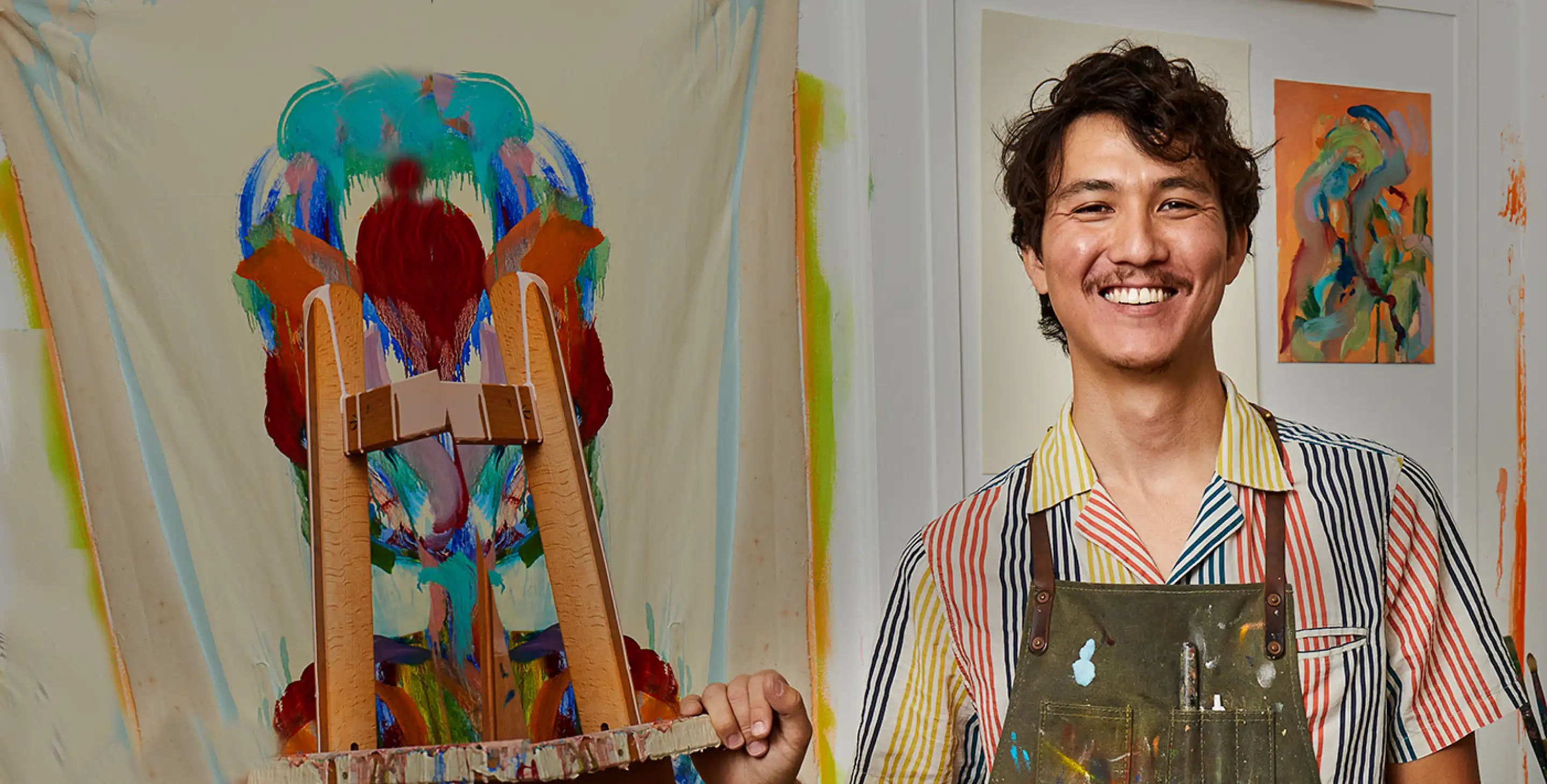 Young Asian American man in painting studio